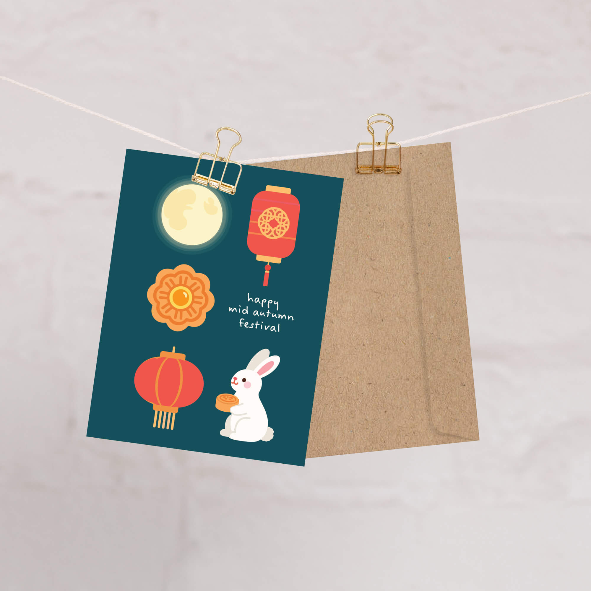 Card with illustrations of a rabbit, moon, and lanterns on a string with clips.