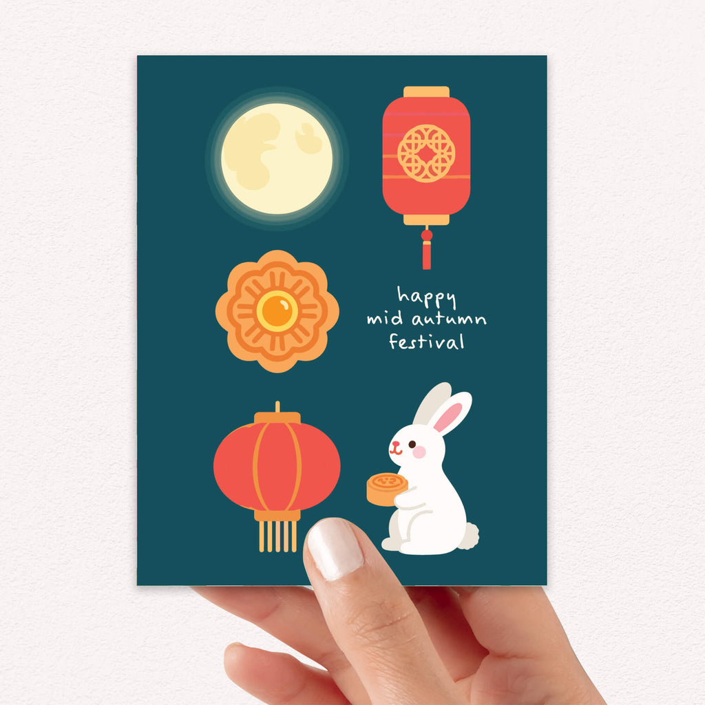 mid autumn festival Greeting card with illustrations of a moon, lanterns, a rabbit, and a mooncake on a blue background.