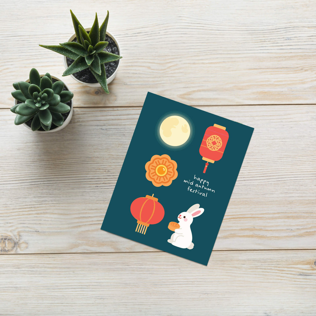 mid autumn festival Greeting card with illustrations of a moon, lanterns, a rabbit, and a mooncake on a blue background.