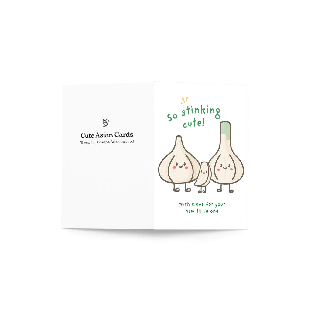 A funny new baby shower card with a cute cartoon garlic illustration and green text reading 'so stinking cute!' and 'much closer for your new little one.' The card is shown open against a plain white background, with the brand name 'Cute Asian Cards' printed on the left side.