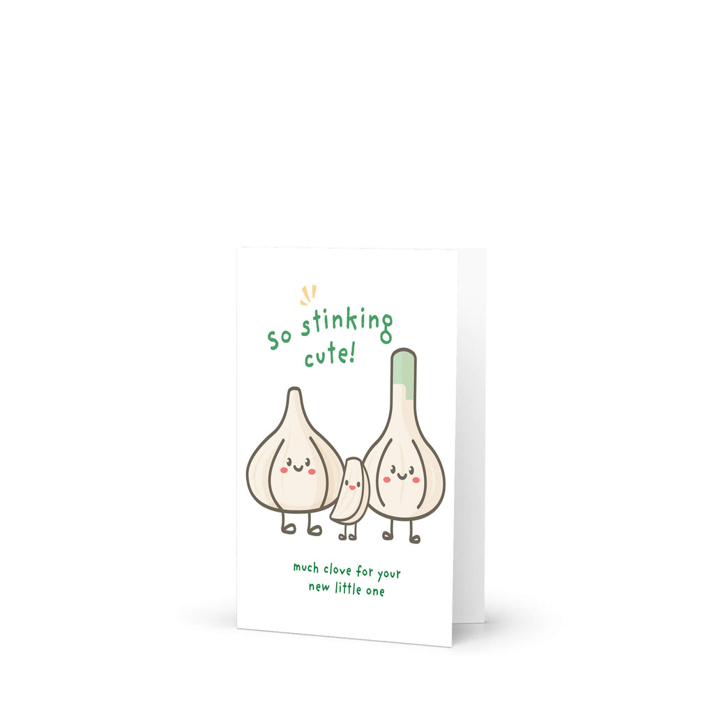 A new baby card featuring a cute illustration of three smiling garlic bulbs with the text 'so stinking cute!' and 'much love for you! new little one' on a clean white background.