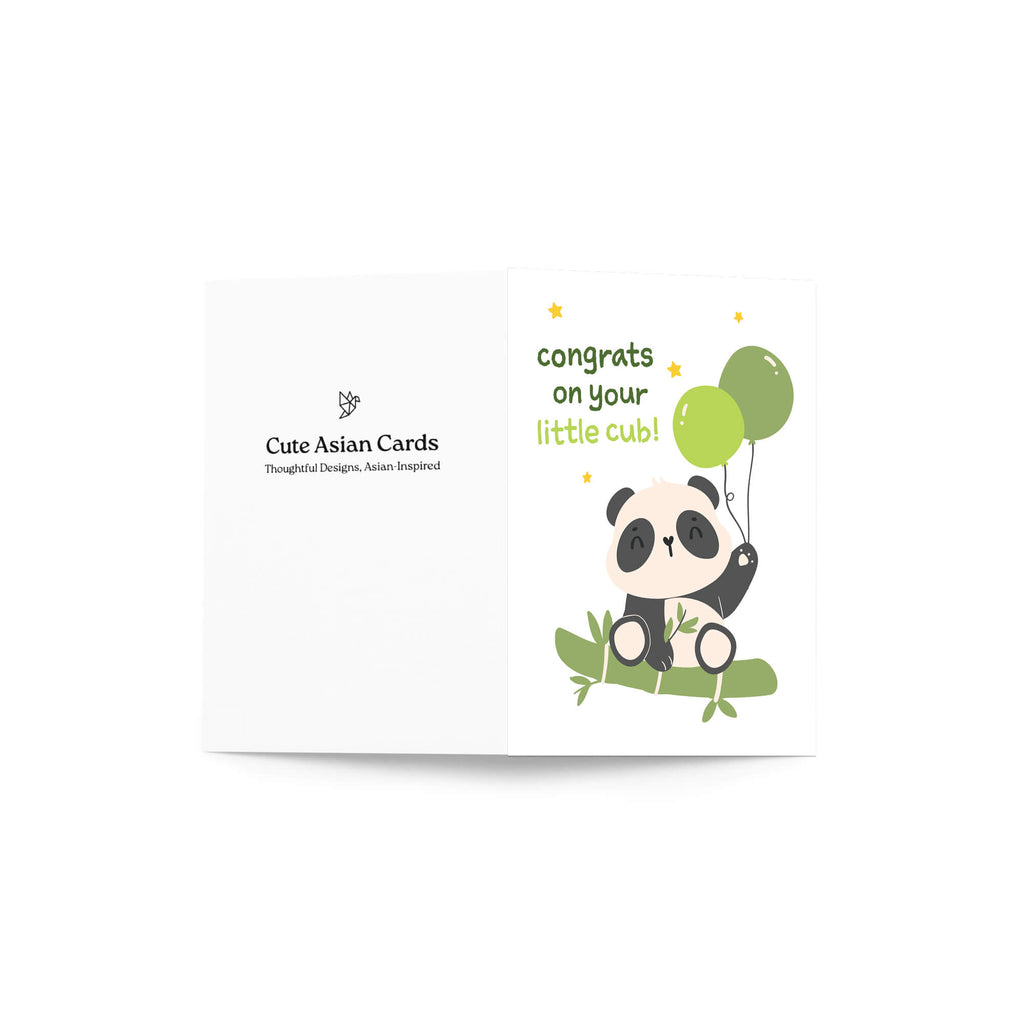 A folded newborn baby card shown open against a white background. The left panel reads 'Cute Asian Cards' with a small logo, and the right panel features a cartoon panda sitting on bamboo with green balloons and the text 'congrats on your little cub!'.