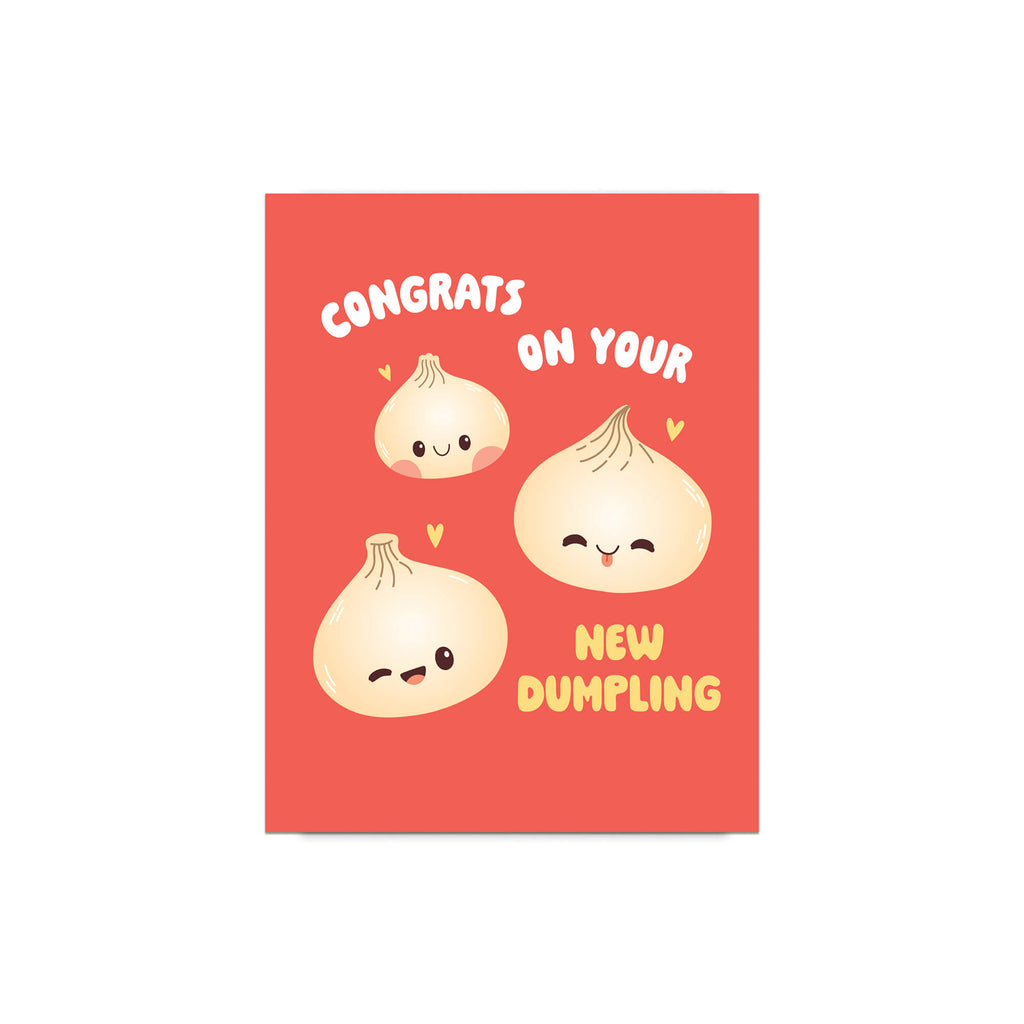 A rectangular greeting card with a coral-red background featuring three cute cartoon dumplings and the text 'CONGRATS ON YOUR NEW DUMPLING' in white and yellow lettering.