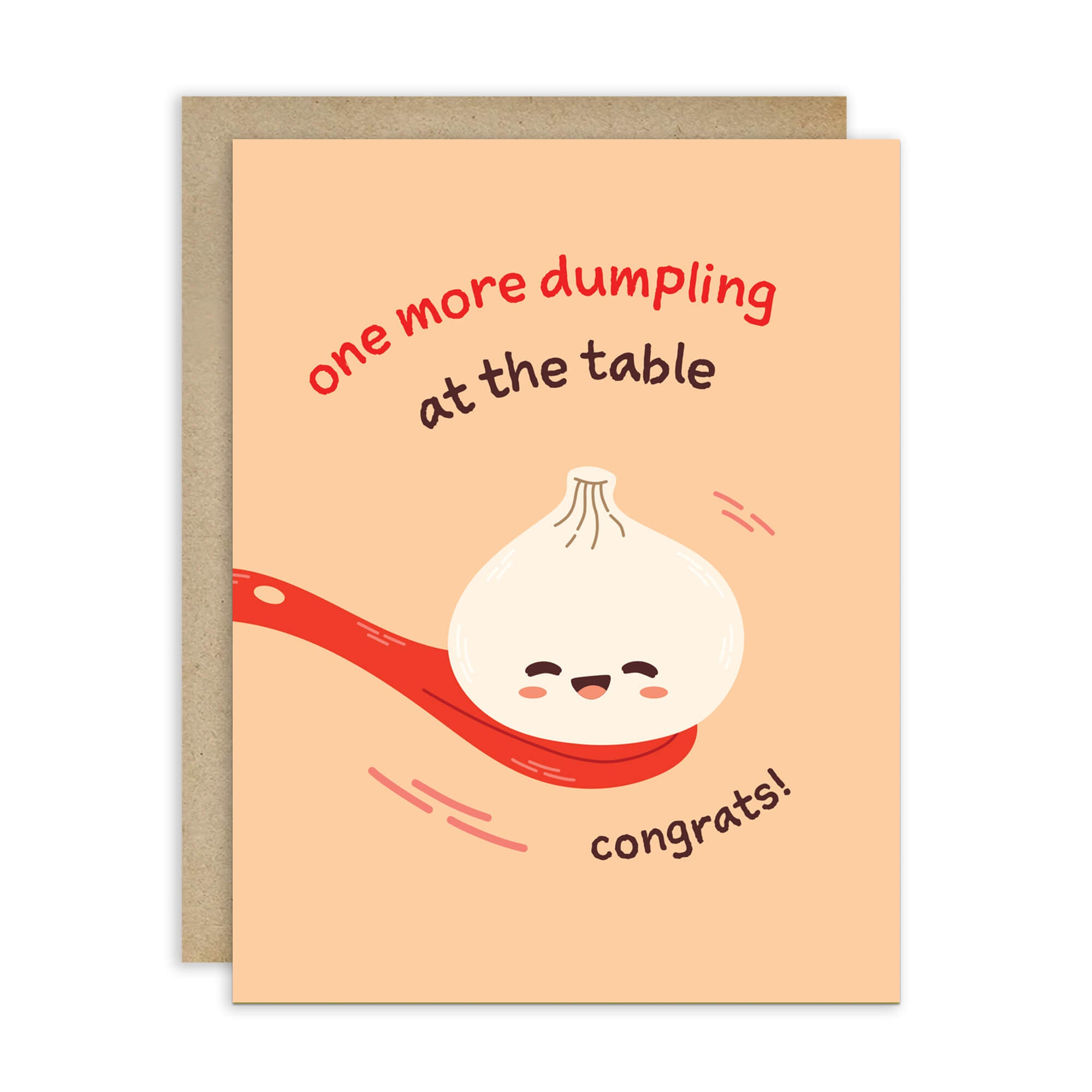 A baby shower card with a peach background and kraft envelope. The card features a cute cartoon dumpling face on a red spoon with the text 'one more dumpling at the table' and 'congrats!'.