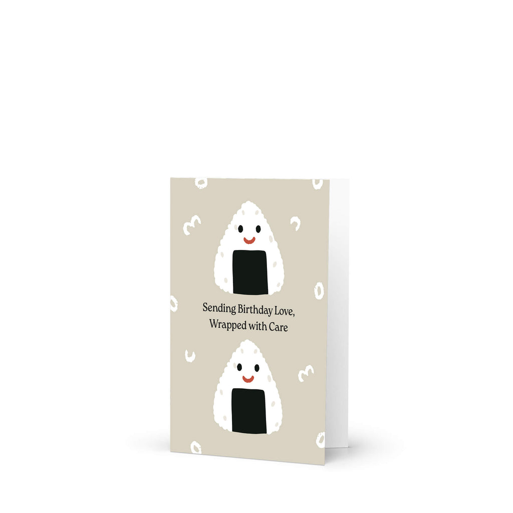 asian Greeting card with japanese onigiri rice balls and birthday message on a beige background