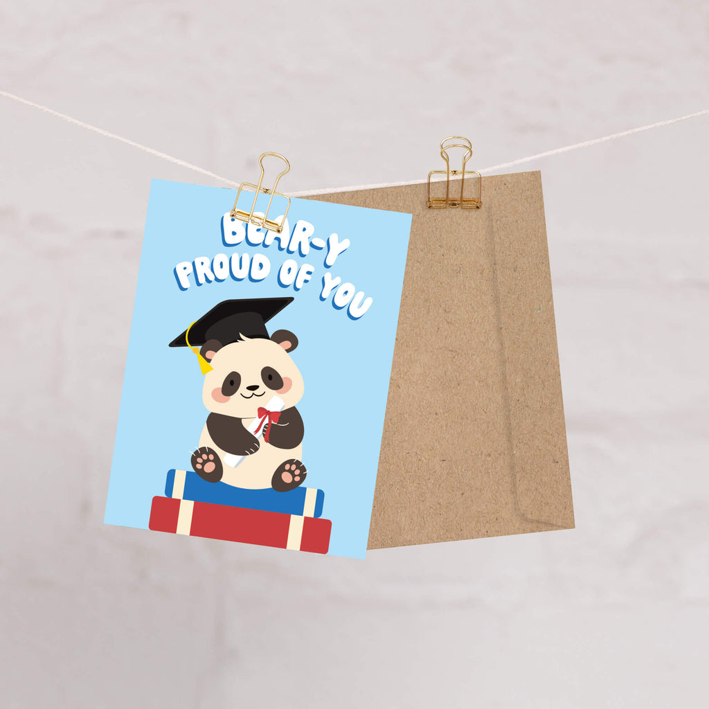 cute graduation card with a panda bear wearing a graduation cap and text 'Bear-y Proud of You' on a blue background.