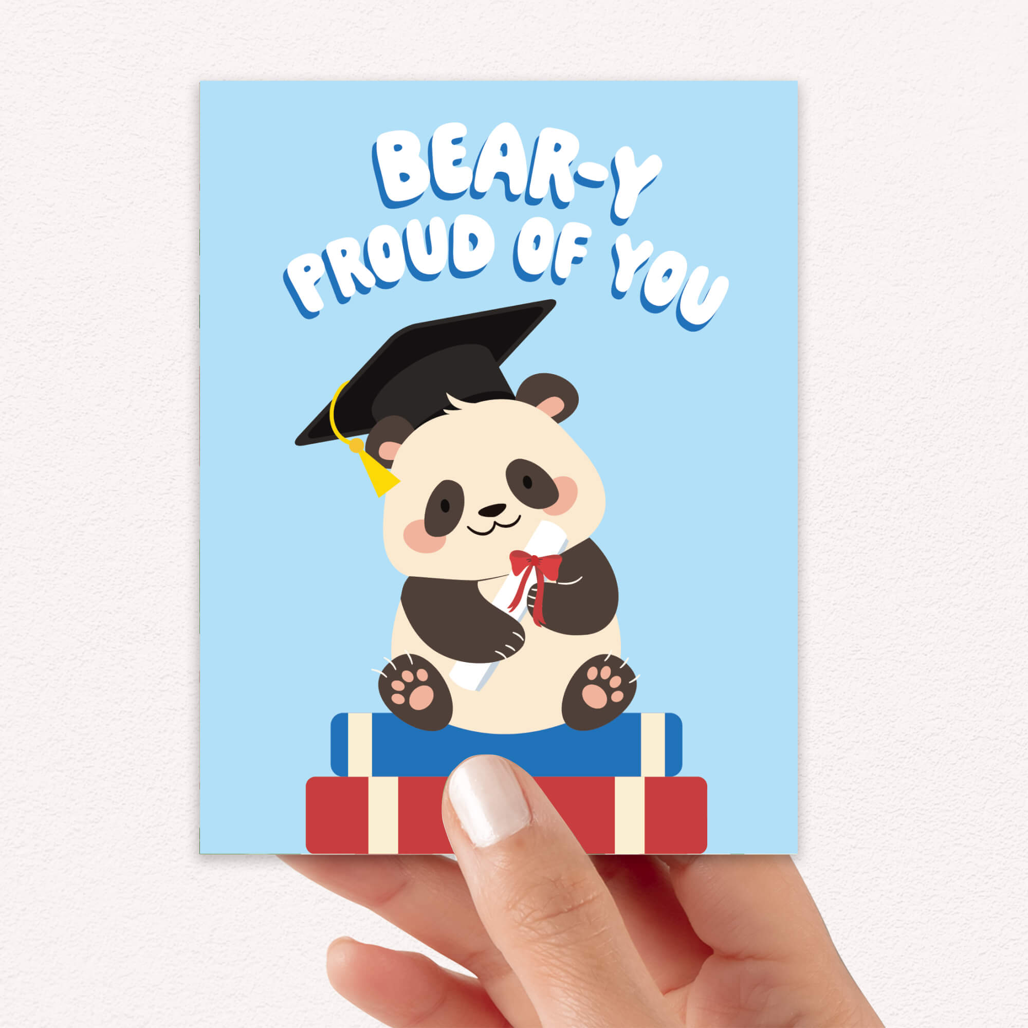 cute graduation card with a panda bear wearing a graduation cap and text 'Bear-y Proud of You' on a blue background.