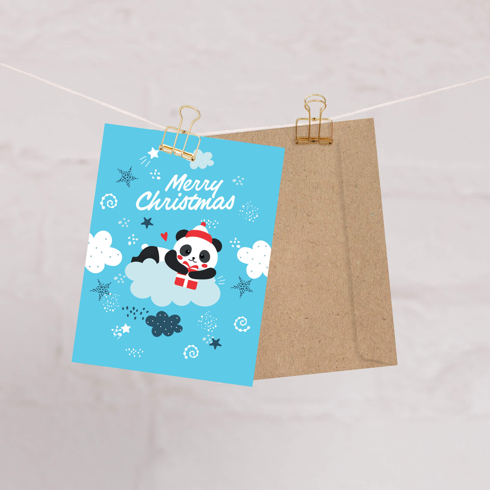 cute christmas card with A panda wearing a Santa hat floats on a cloud holding a red gift box. Surrounded by stars and snowflakes. Text reads “Merry Christmas.”