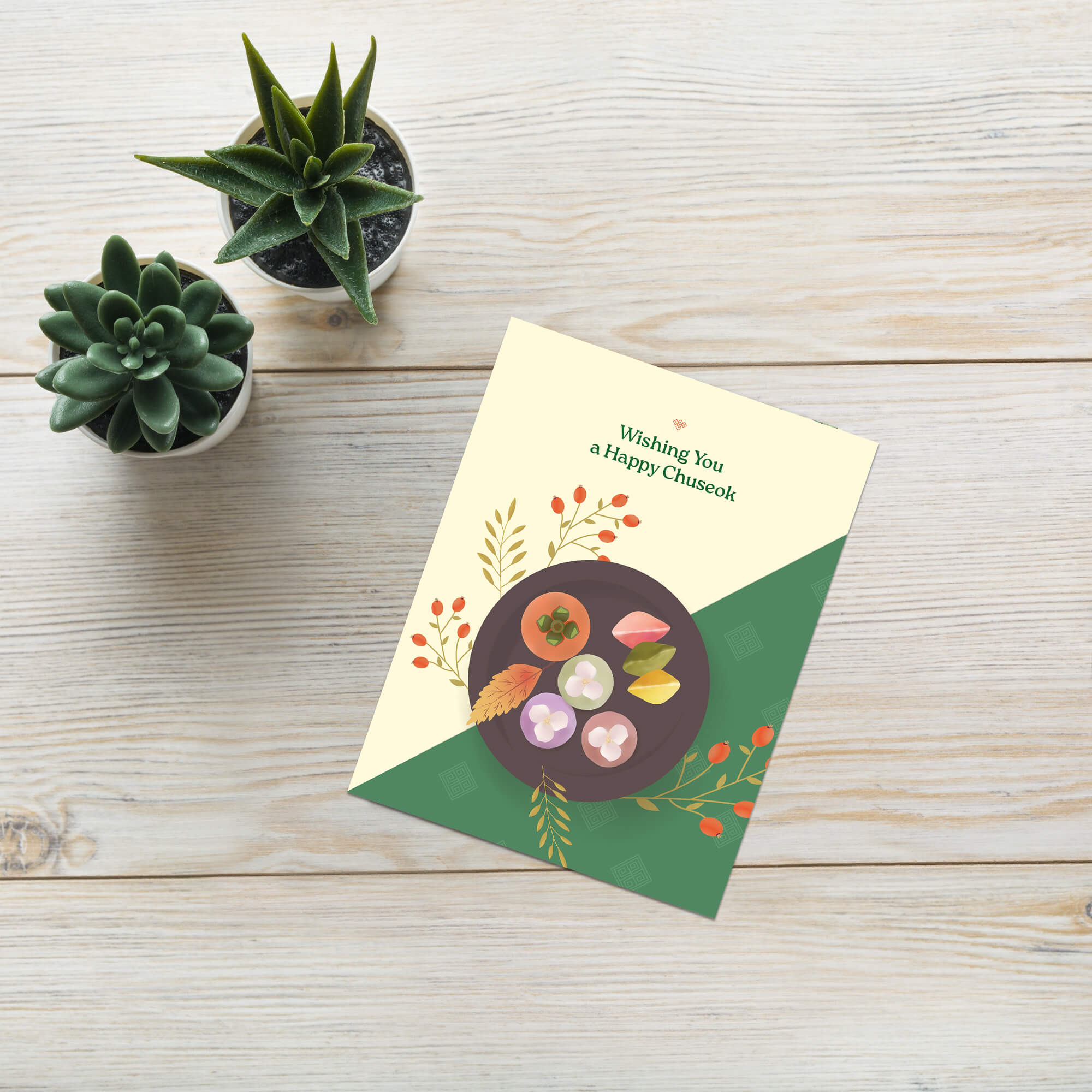 korean Greeting card with a plate of traditional Korean dishes Persimmon, Songpyeon & Hangwa for mid autumn festival  on a green and beige background.