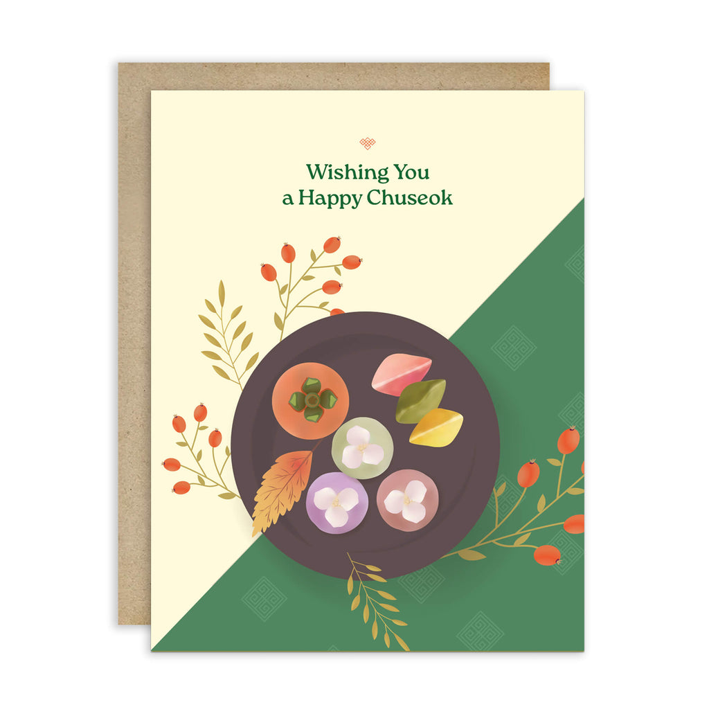 korean Greeting card with a plate of traditional Korean dishes Persimmon, Songpyeon & Hangwa for mid autumn festival  on a green and beige background.