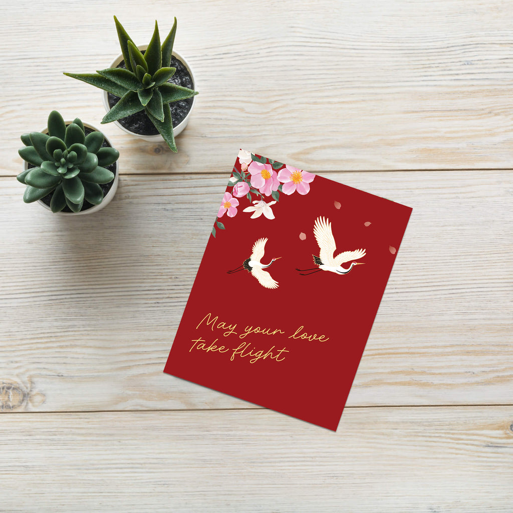 Red wedding chinese vietnamese card with white cranes, pink flowers, and 'May your love take flight' text on a white background