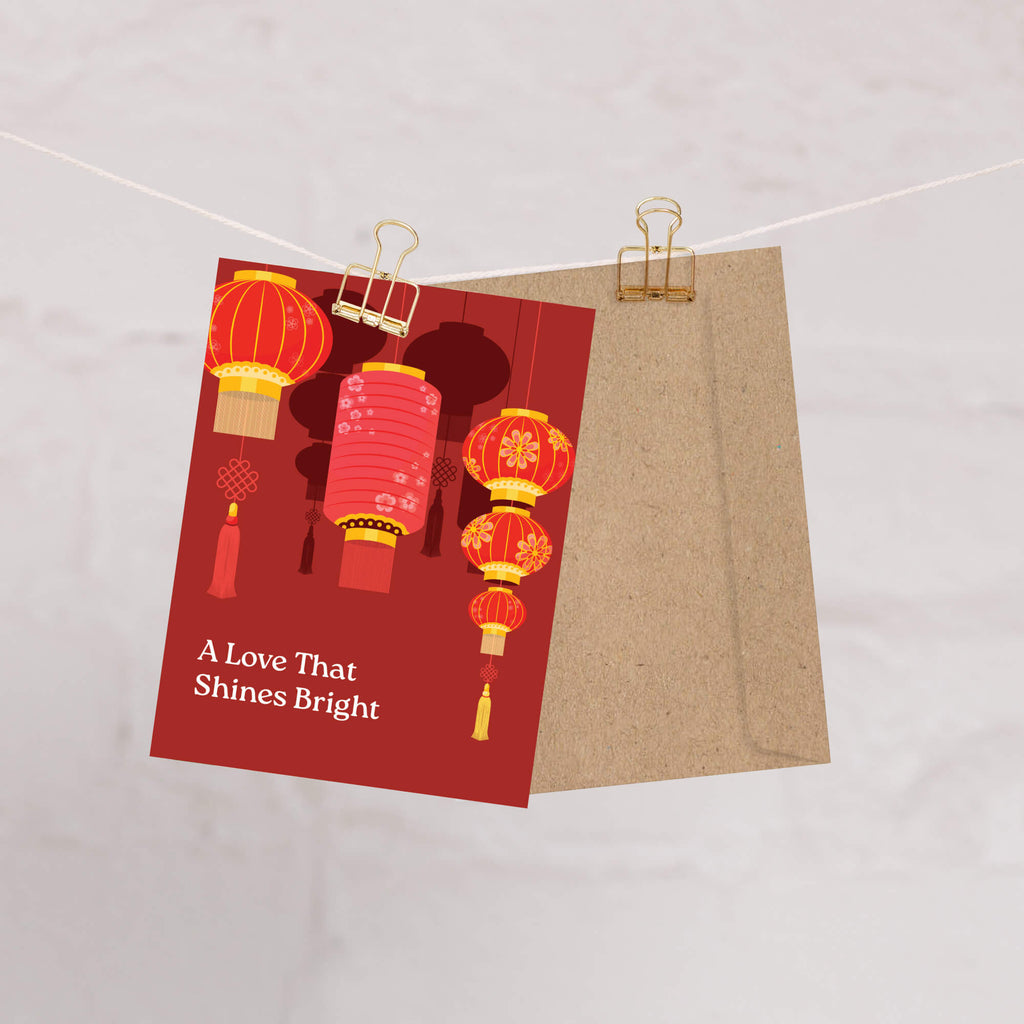 chinese wedding Greeting card with red lanterns and text 'A Love That Shines Bright' on a red background