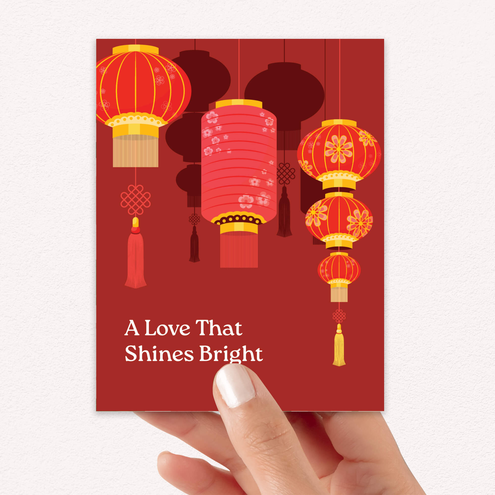 chinese wedding Greeting card with red lanterns and text 'A Love That Shines Bright' on a red background