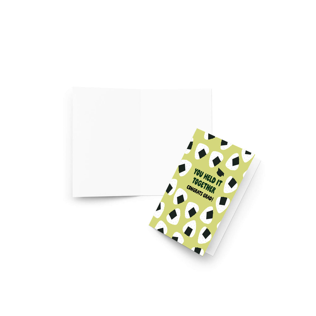 Graduation card with japanese onigiri rice ball pattern and text 'You held it together. Congrats grad!' on a white background.