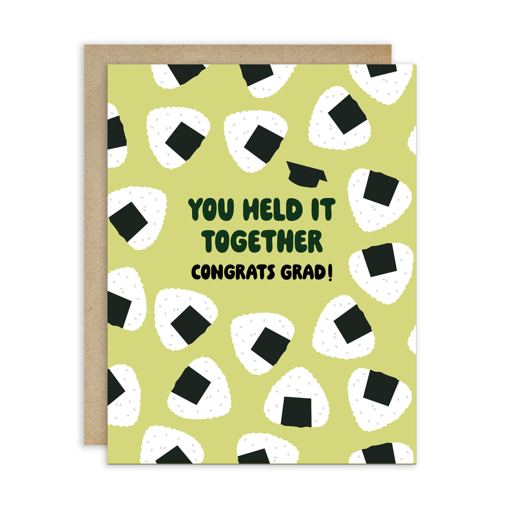 Graduation card with japanese onigiri rice ball pattern and text 'You held it together. Congrats grad!' on a white background.