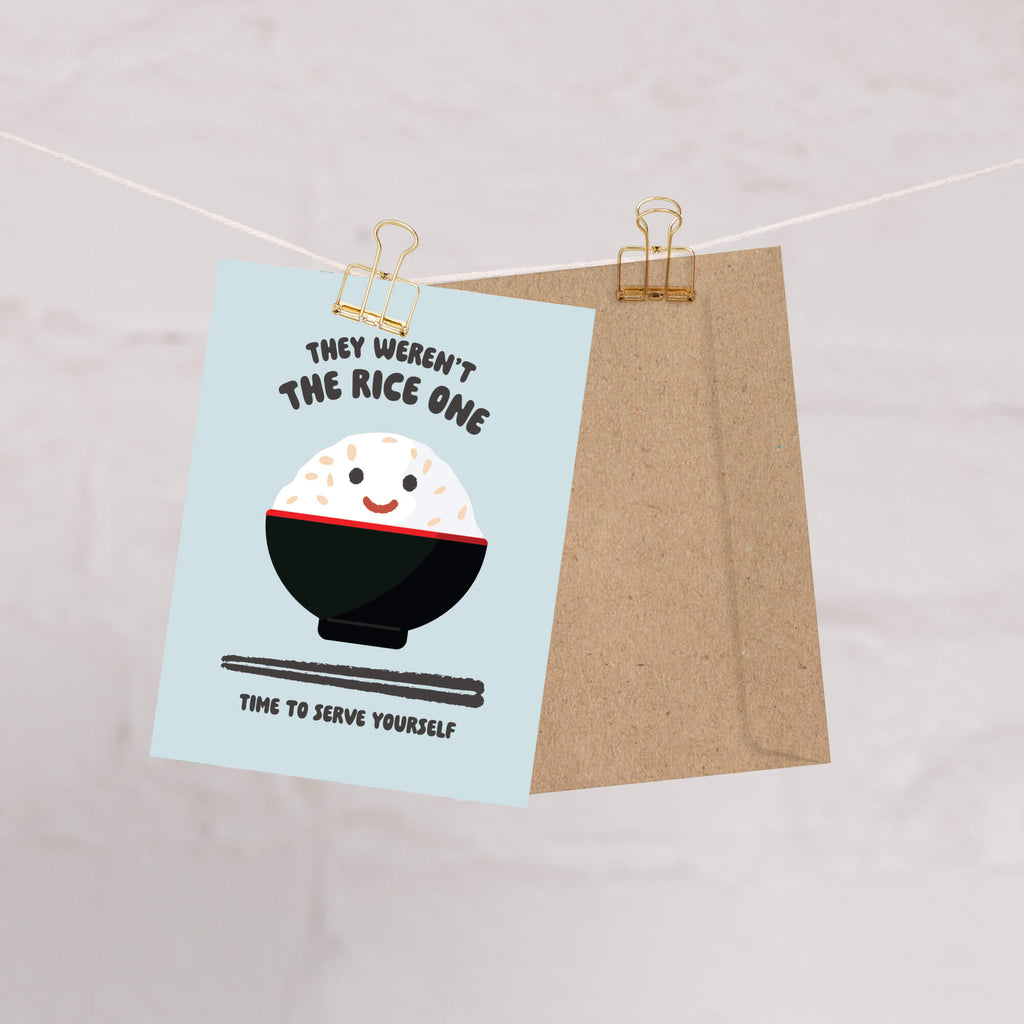 Cartoon illustration of a bowl of rice with text on a light blue background, clipped to a string.