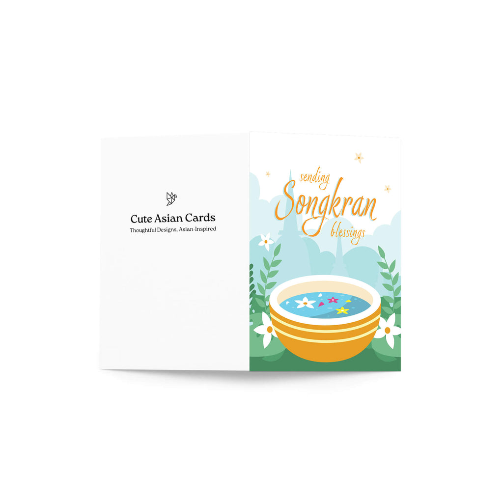 thai new year card with a bowl of spa water and flowers, featuring 'sending Songkran blessings' text.