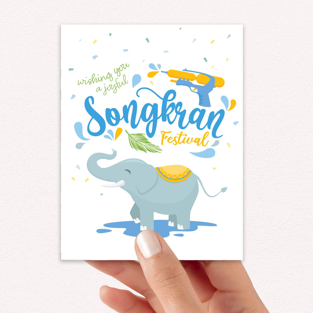 thai new year Greeting card with an elephant and Songkran Festival text on a white background
