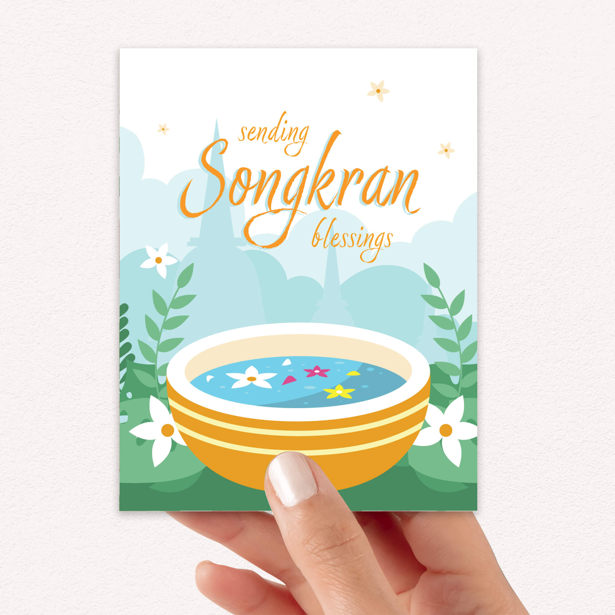 thai new year card with a bowl of spa water and flowers, featuring 'sending Songkran blessings' text.