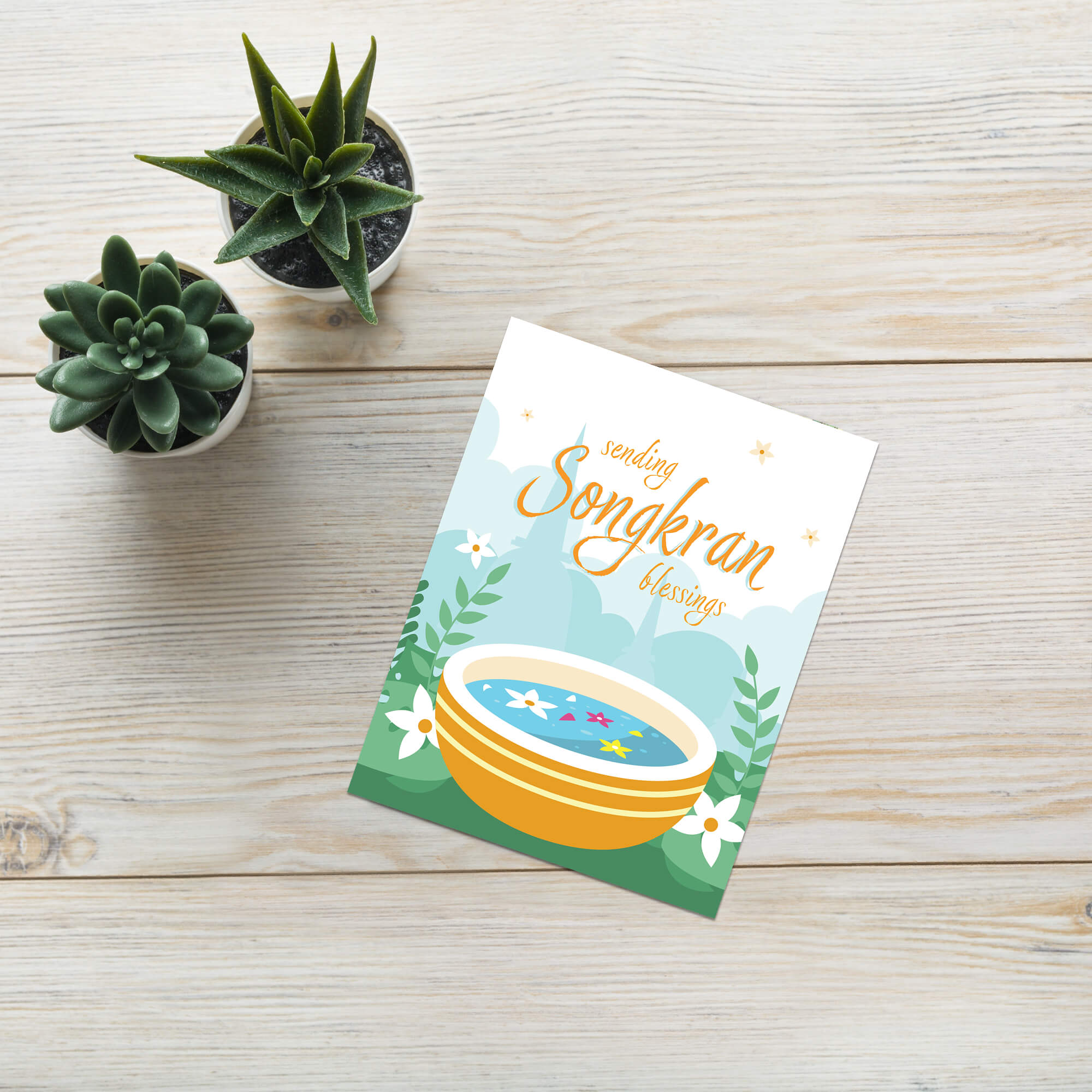 thai new year card with a bowl of spa water and flowers, featuring 'sending Songkran blessings' text.