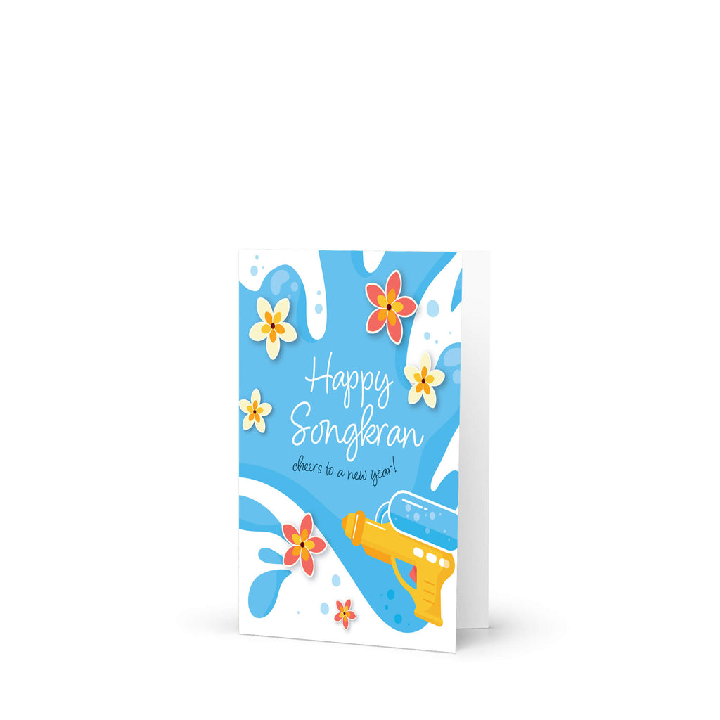 Greeting card with 'Happy Songkran' for Thai New Year with flowers and a water soaking squirt gun on a blue background.