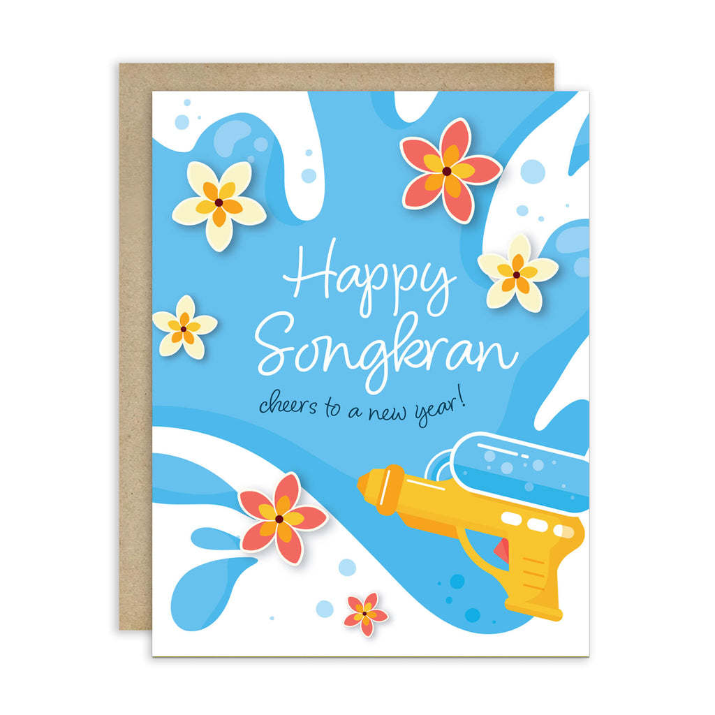 Greeting card with 'Happy Songkran' for Thai New Year with flowers and a water soaking squirt gun on a blue background.