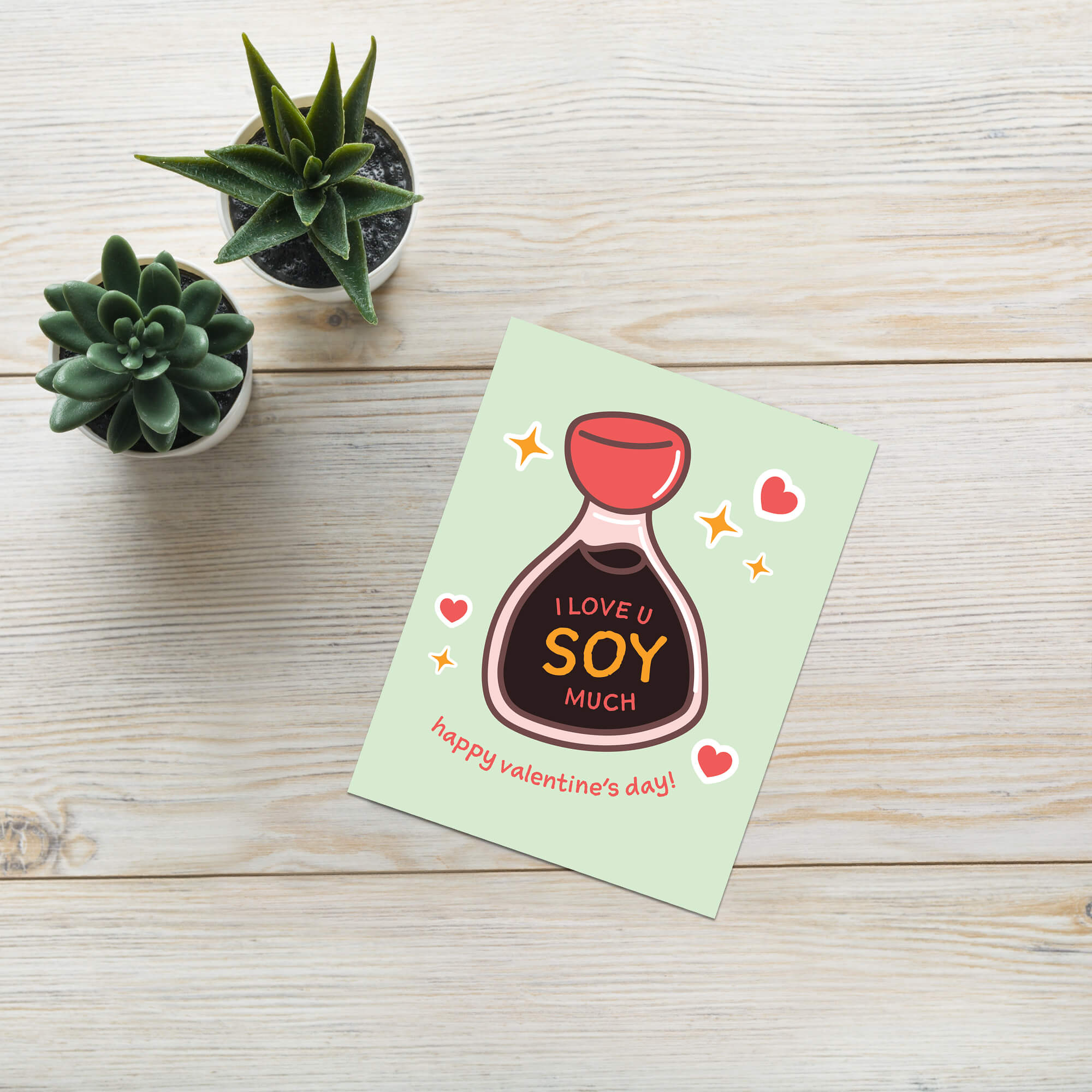 Smiling soy sauce bottle on mint with hearts; label says “I love u soy much.”