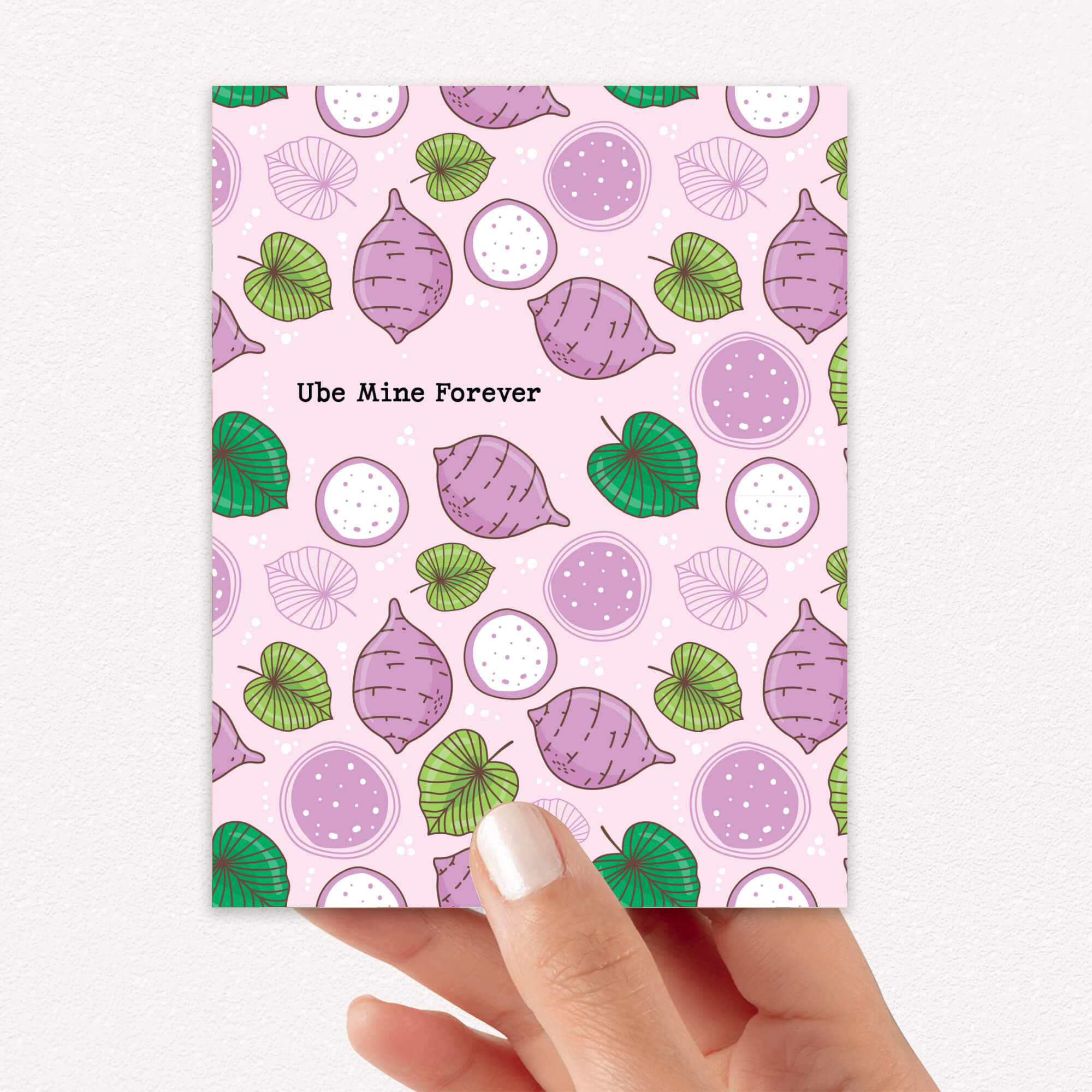 Notebook with ube (purple yam) pattern and 'Ube Mine Forever' text held by a hand.
