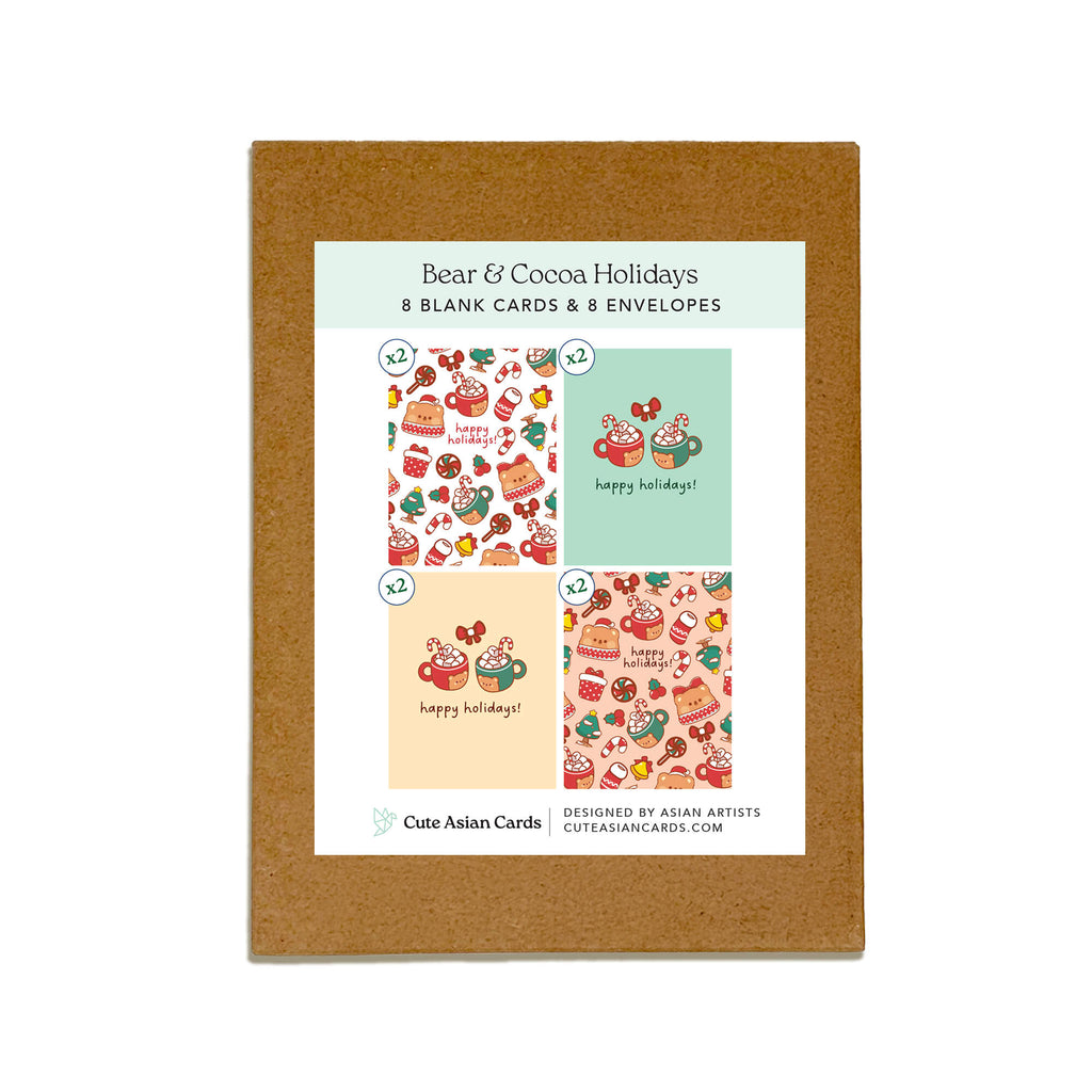 Bear & Cocoa holiday card pack showing 4 warm and festive designs featuring mugs of hot chocolate with bear faces, candy canes, and holiday treats. Each design appears twice for a total of 8 cards with kraft envelopes.