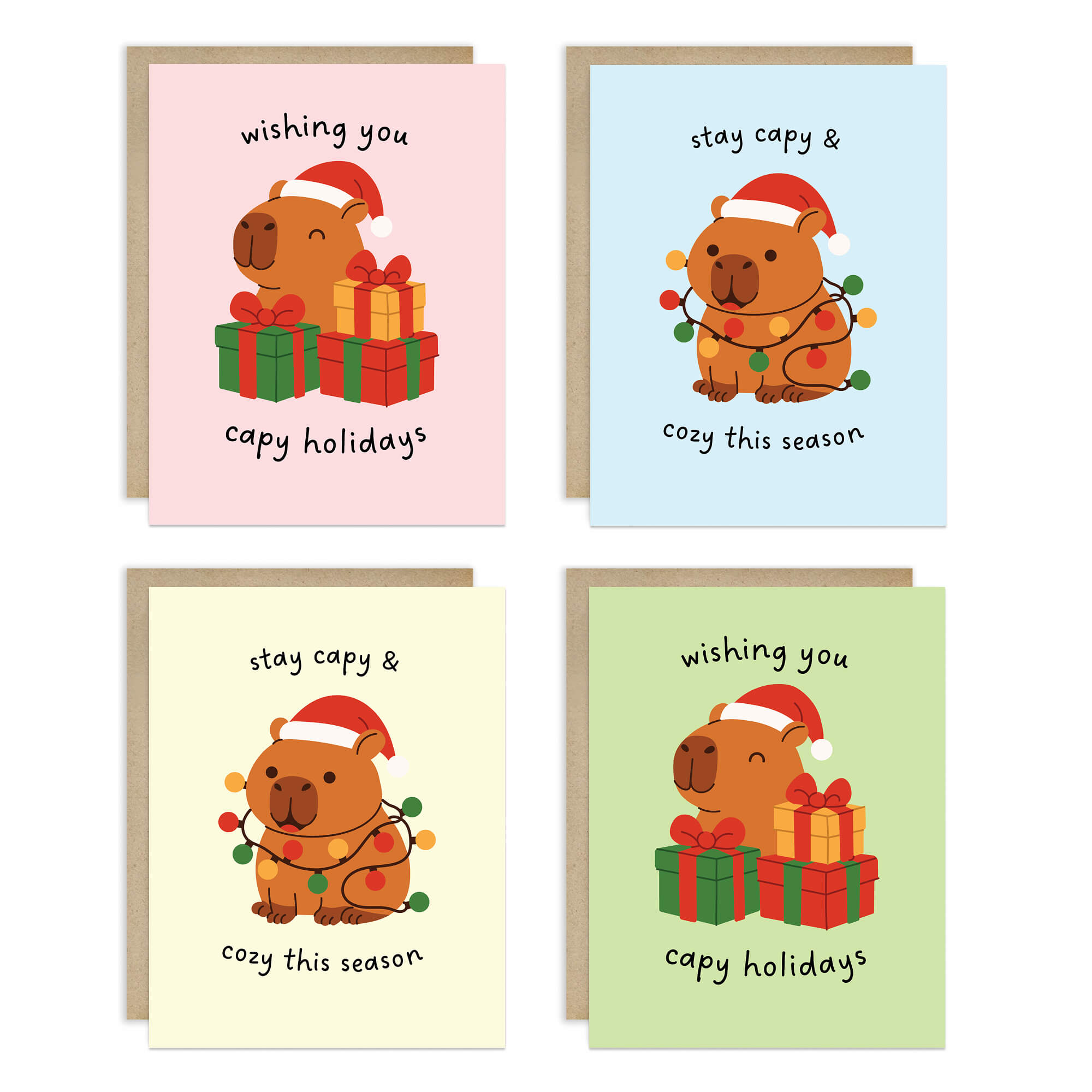 Colorful Capy Holidays card pack showing 4 holiday designs with capybaras in Santa hats, wrapped in string lights or sitting with gift boxes. Each design appears twice for a total of 8 cards with kraft envelopes.