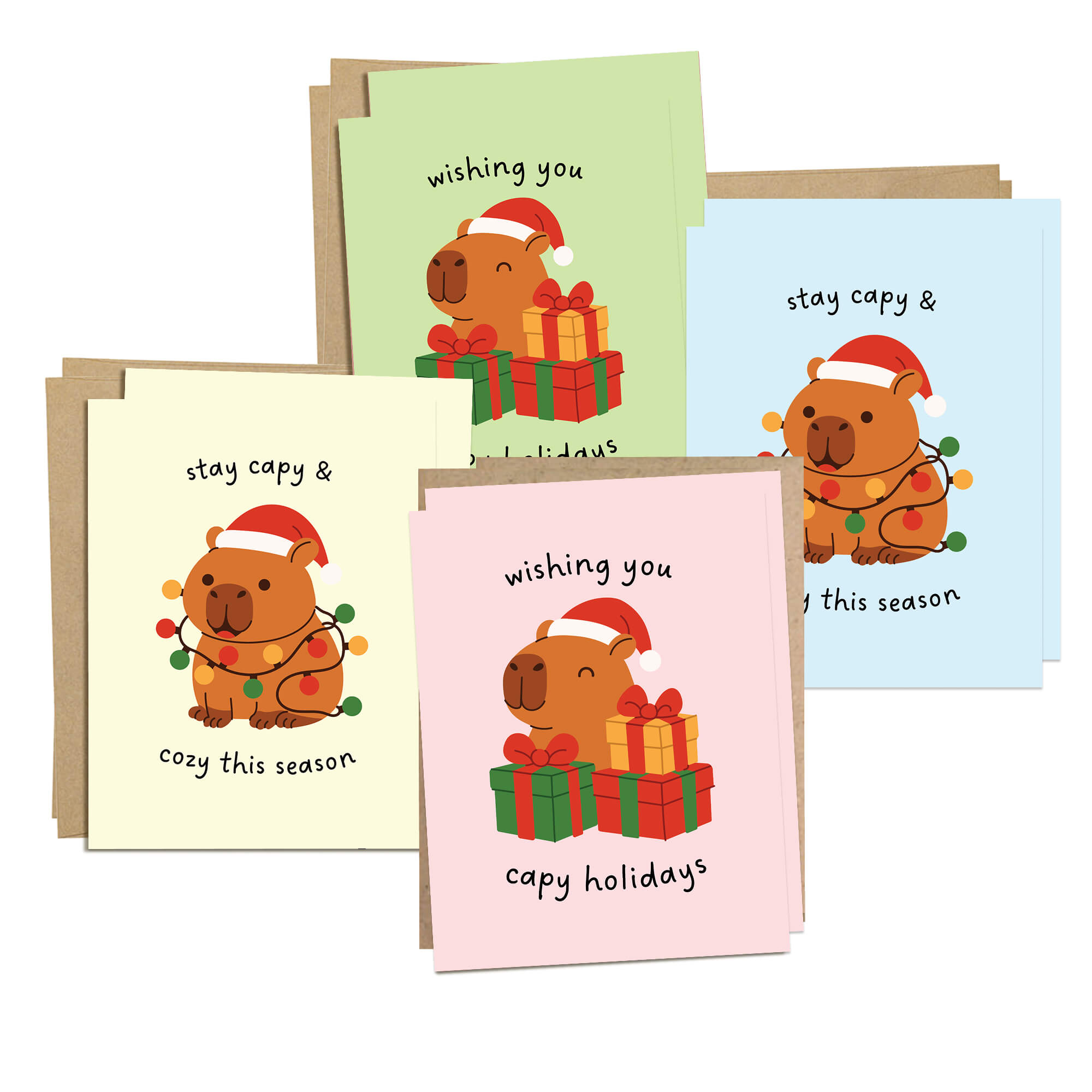 Colorful Capy Holidays card pack showing 4 holiday designs with capybaras in Santa hats, wrapped in string lights or sitting with gift boxes. Each design appears twice for a total of 8 cards with kraft envelopes.