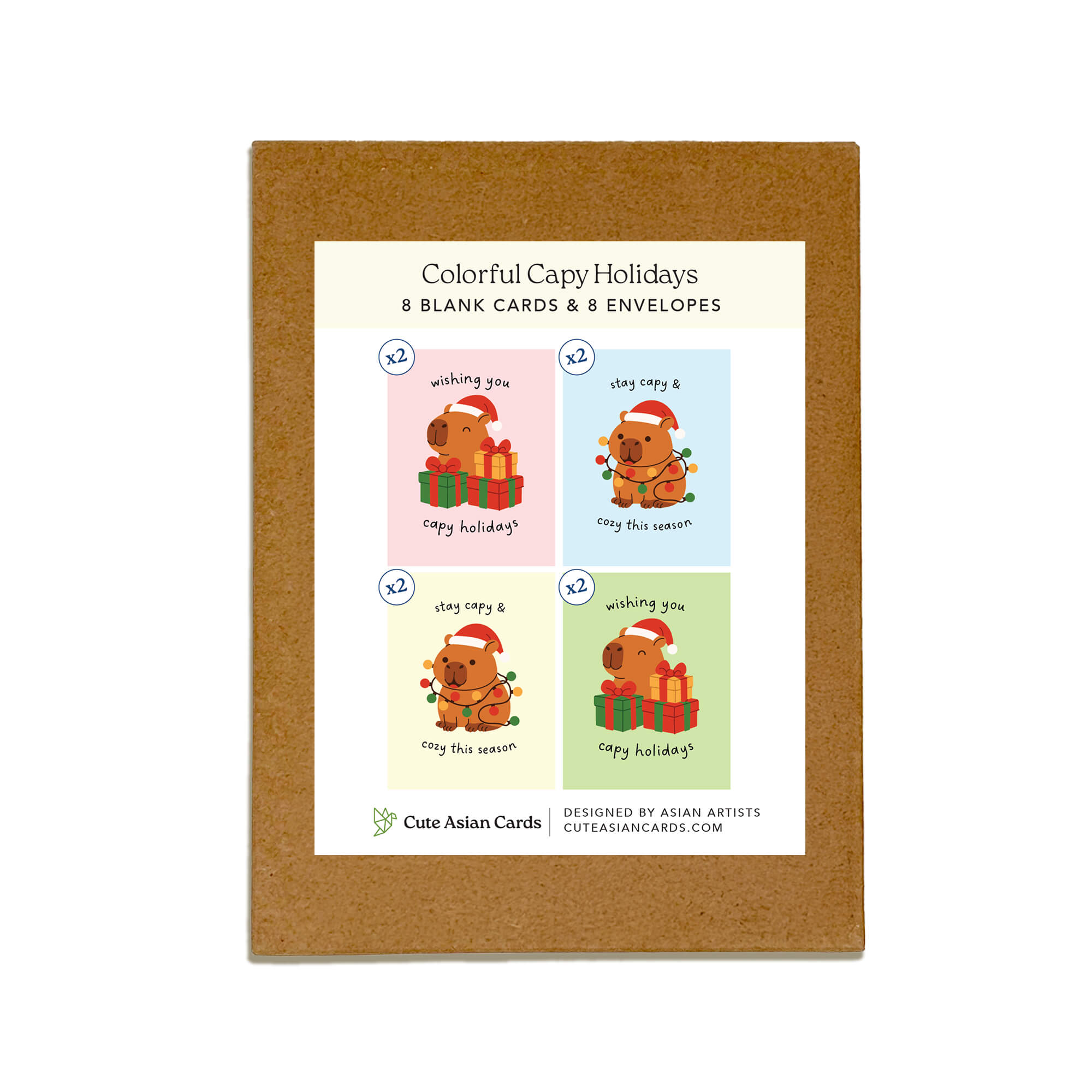 Colorful Capy Holidays card pack showing 4 holiday designs with capybaras in Santa hats, wrapped in string lights or sitting with gift boxes. Each design appears twice for a total of 8 cards with kraft envelopes.
