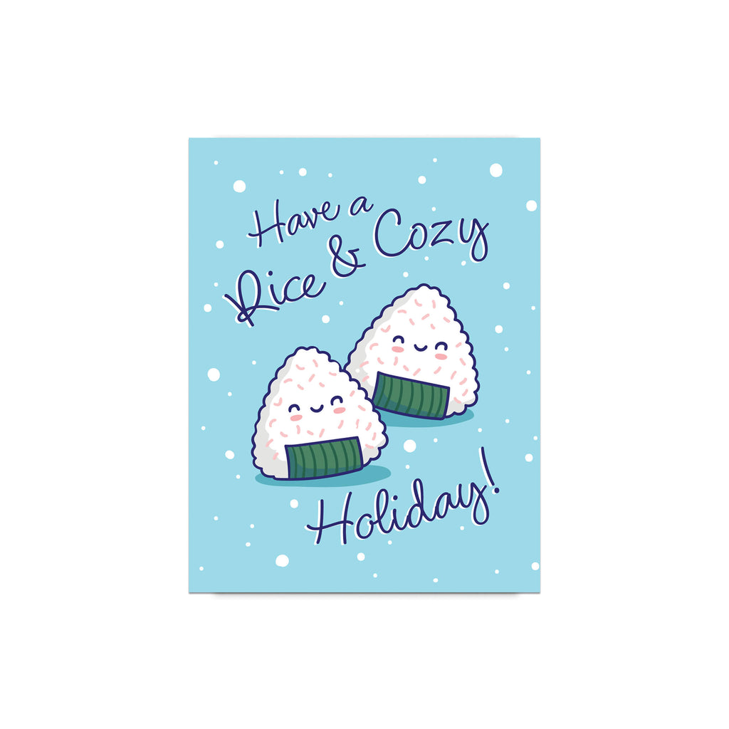 unique christmas card with Two smiling onigiri (japanese rice ball snacks) on snowy blue with text “Have a Rice & Cozy Holiday.”