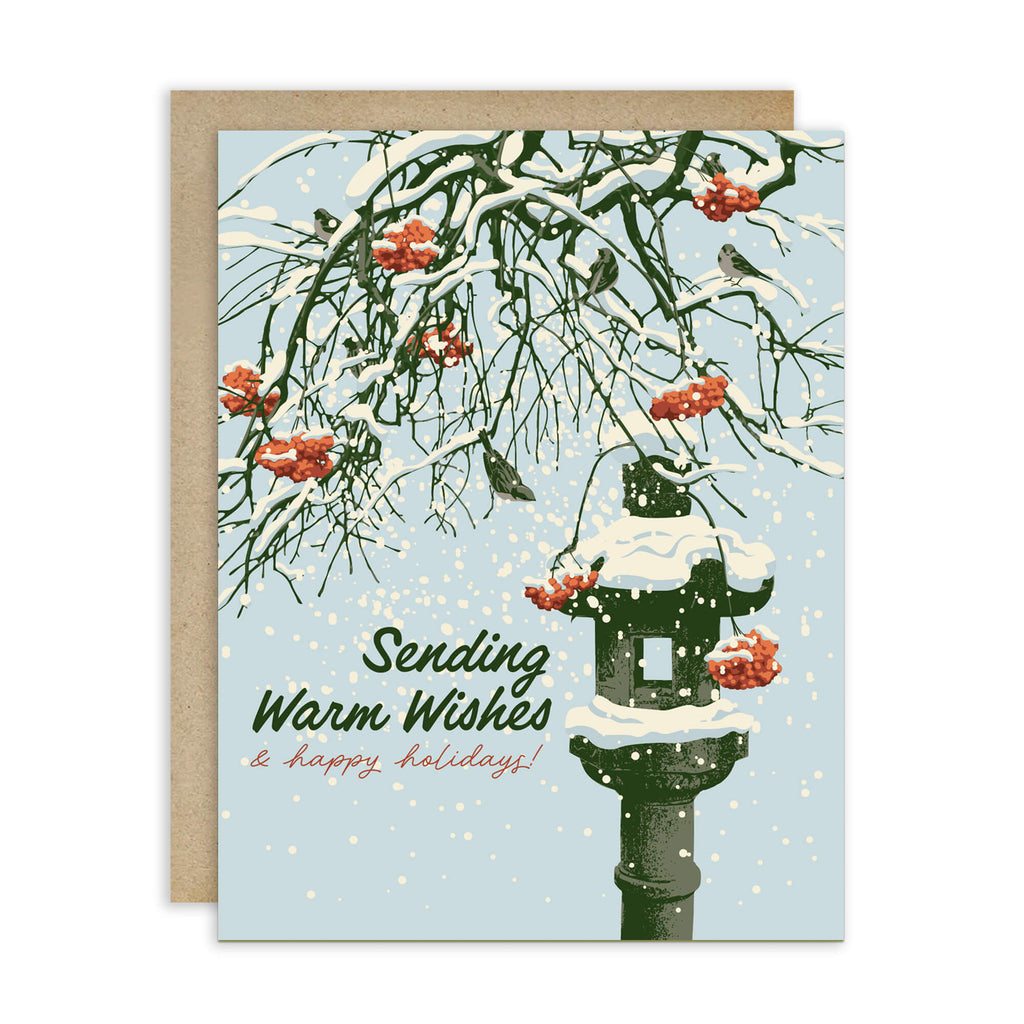 Greeting card with winter scene, snow-covered branches, Snowy ishi-dōrō stone lantern with red berries, and text 'Sending Warm Wishes & happy holidays!'.
