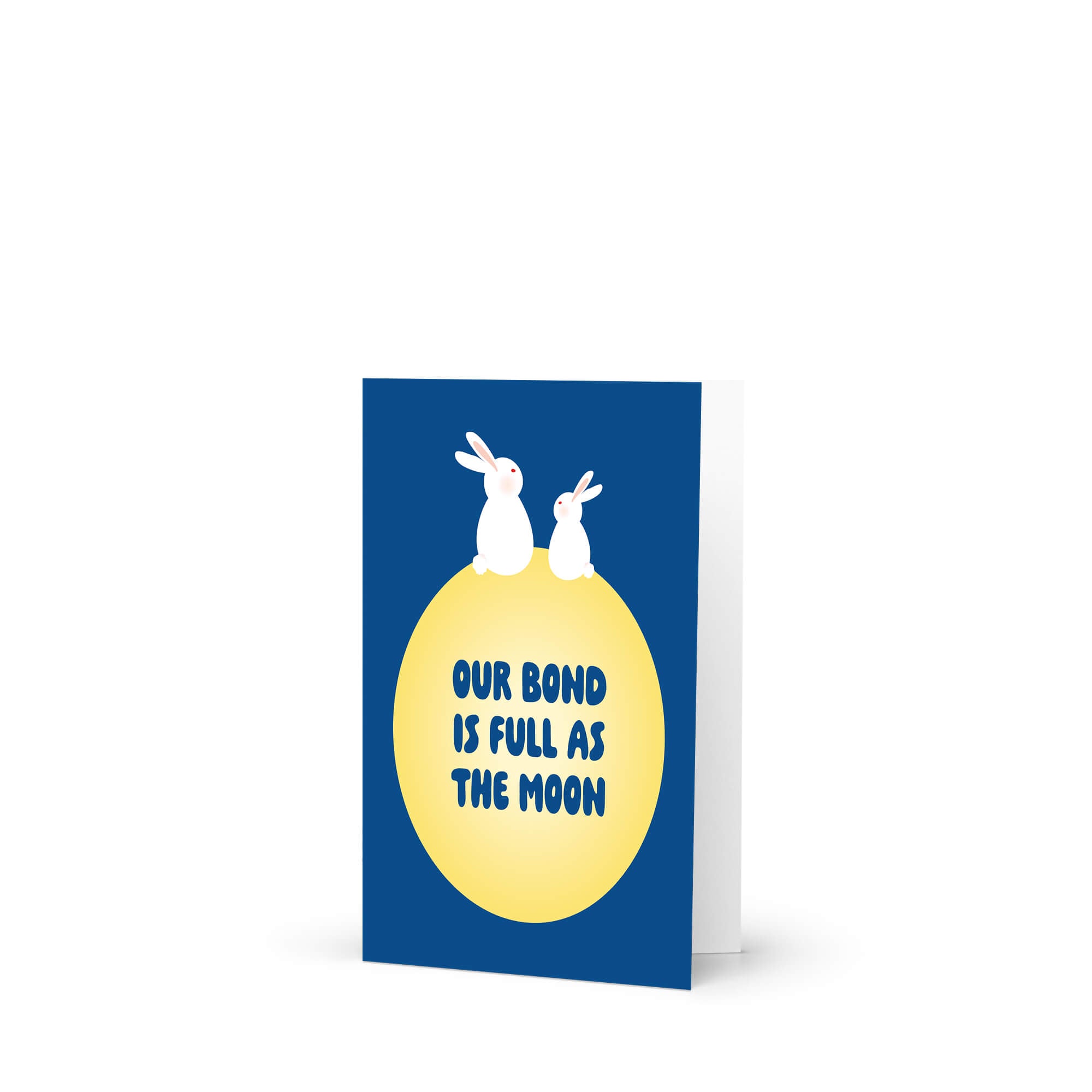 blue asian Greeting card with two rabbits on a yellow moon and 'Our bond is full as the moon' text on a blue background for mid autumn festival tsukimi or chuseok 