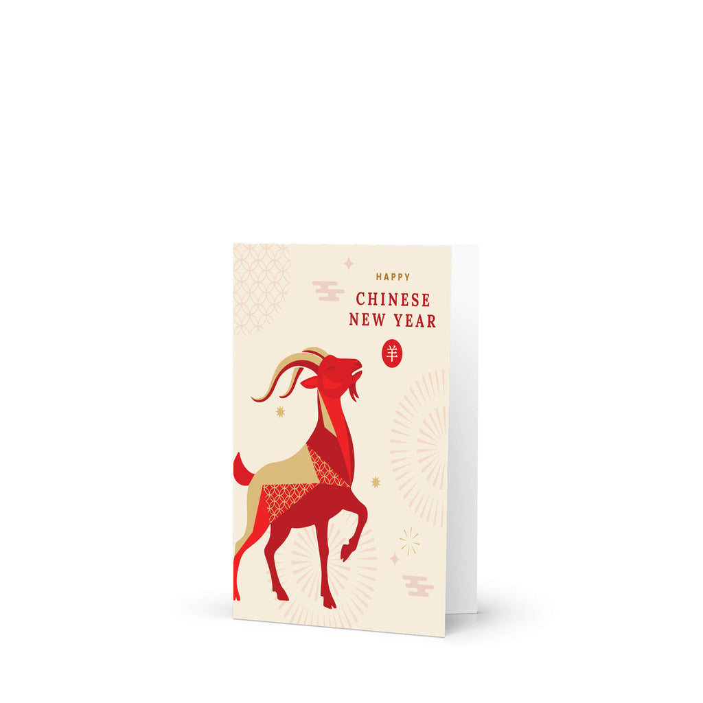 A chinese new year card featuring a stylized red and gold goat illustration with the text 'Happy Chinese New Year' on a cream background, shown standing against a white studio backdrop.