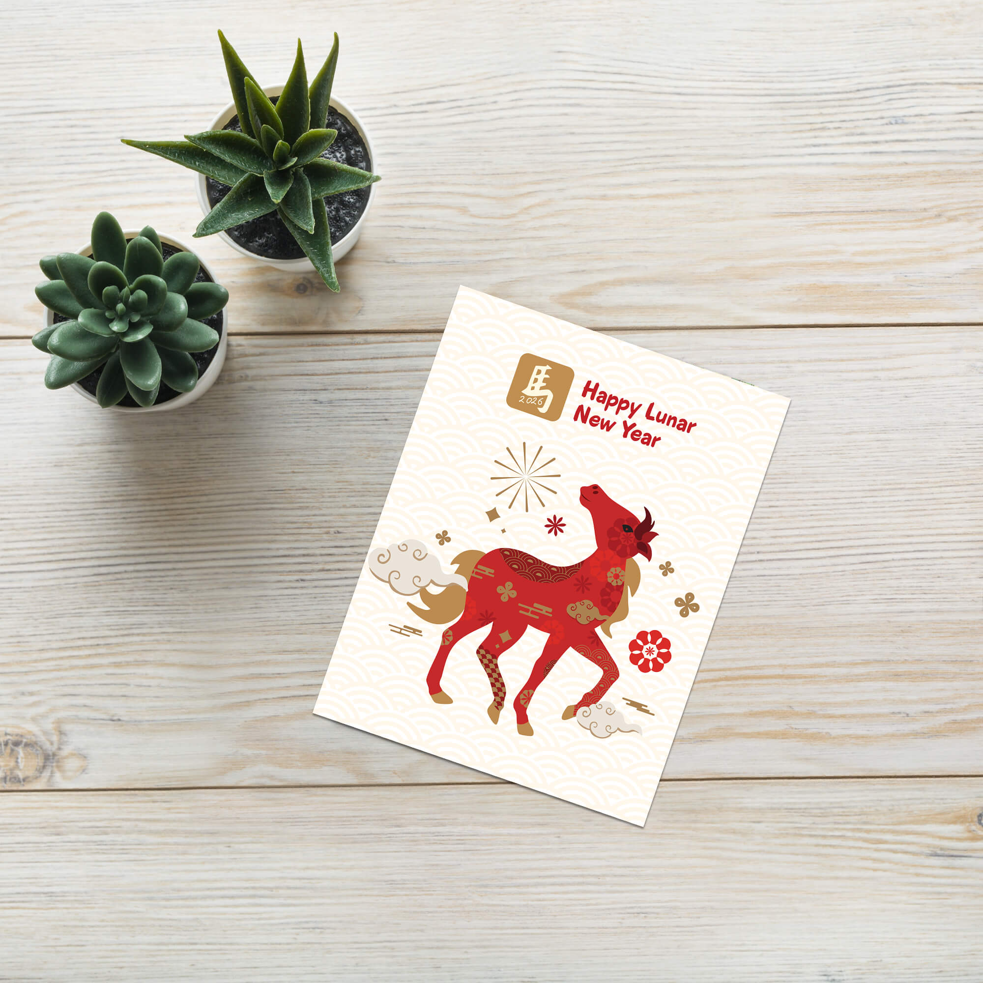 Lunar New Year card with a red deer illustration on a wooden surface with small plants.