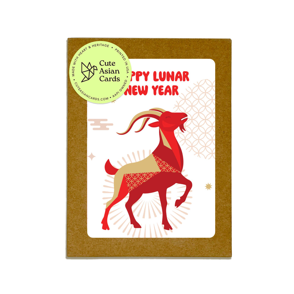 boxed set of chinese new year cards and a white center panel reading 'HAPPY LUNAR NEW YEAR' in red, featuring a stylized red and beige goat illustration. A round green sticker on the top left reads 'Cute Asian Cards' and includes the website cuteasiancards
